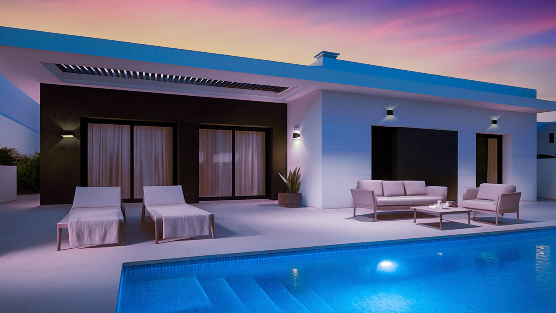 Villa with illuminated pool at dusk