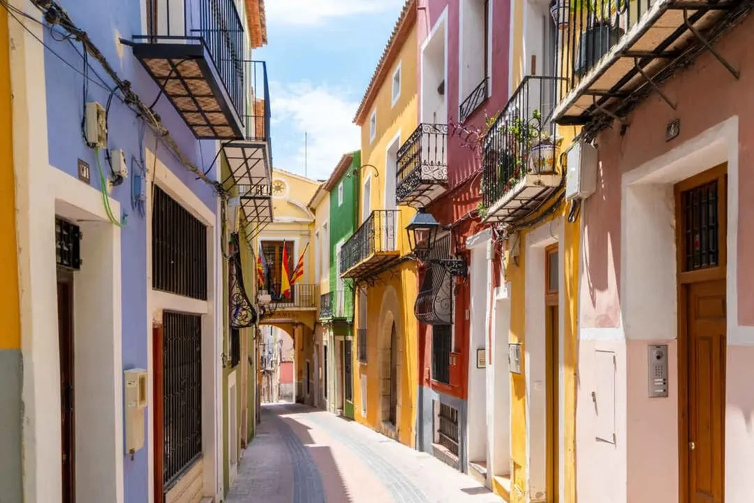 Colourful old-town lane with wrought-iron balconies