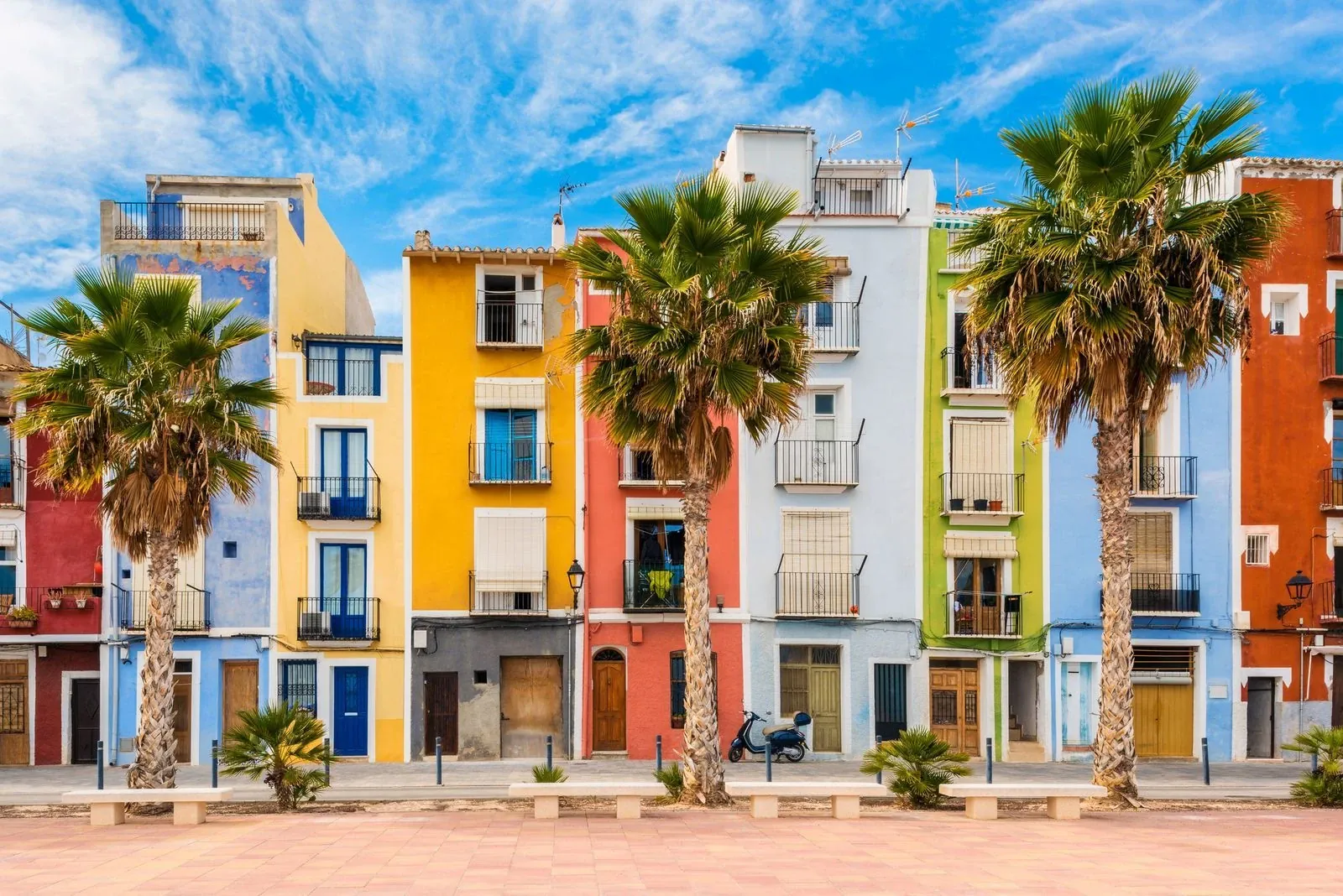 The colourful row of houses with palms on the promenade