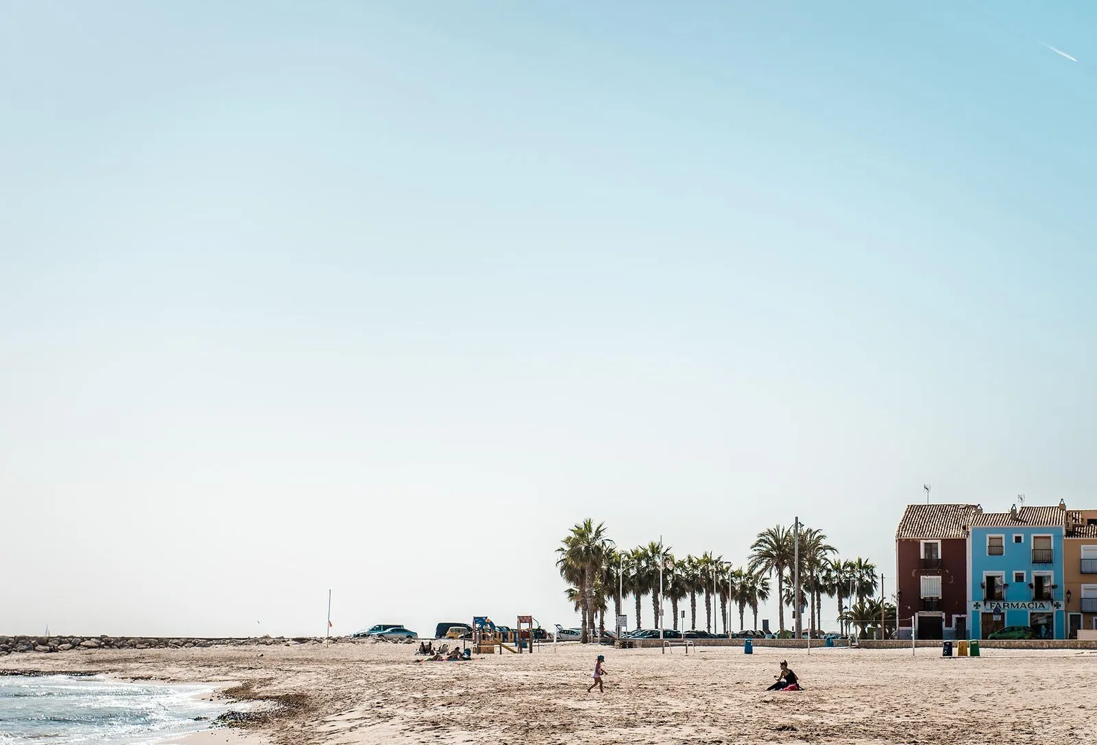 Wide sandy beach at the edge of the old town